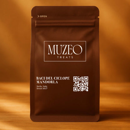 <div style="text-align: center;"> <span style="color: #1D1919;">Baci del Ciclope Mandorla (3.5 oz.)</span><br><span style="color: #444444;">Sicily, Italy</span> <br> <span style="color: #444444;">Pouch Dims. 6.0" × 3.5" × 2.15"</span> </div> 
